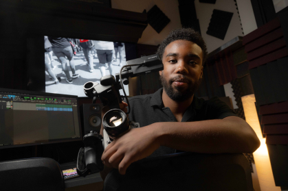Terrance Leon George III in the film studio with his camera in his hand
