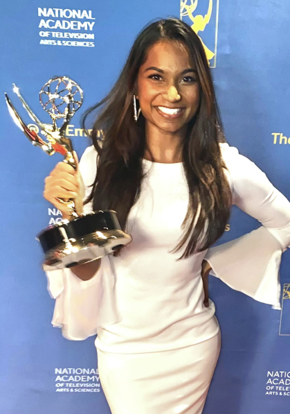 Erica D’Costa holding Emmy Award
