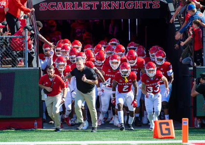 Rutgers football coach Greg Schiano leads the Scarlet Knights onto the field.