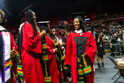 students walking from receiving their Kente stoles