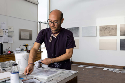 Marc Handelman works in a studio at Surf Point on the coast of Maine as part of a residency program.