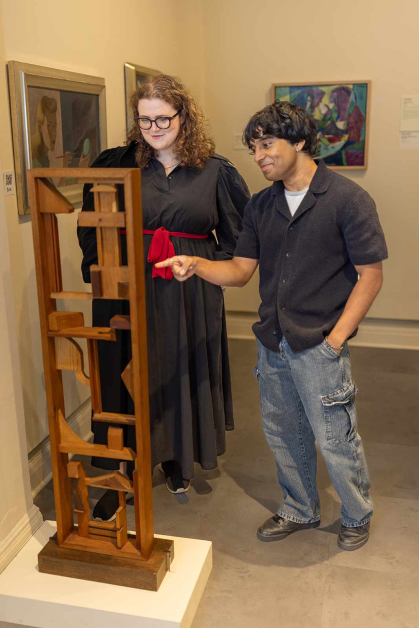 Student educators Megan Mauriello (left) and Roshan Kenath discuss Dorothy Dehner's 1978 sculpture "Window with View."