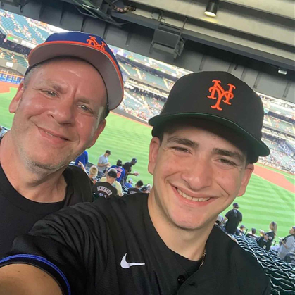 Rutgers-New Brunswick student Tommy Kelson (right) takes a photo with his dad Glenn Kelson during a New York Mets game at Citi Field on Aug. 5, 2022.