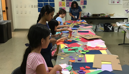 Children work with construction paper during a Summer Art Camp class at the Zimmerli Art Museum.