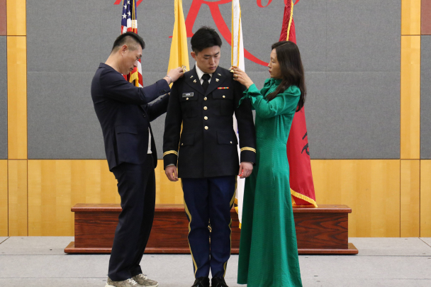 Second Lieutenant Patrick Kwon being pinned by his parents