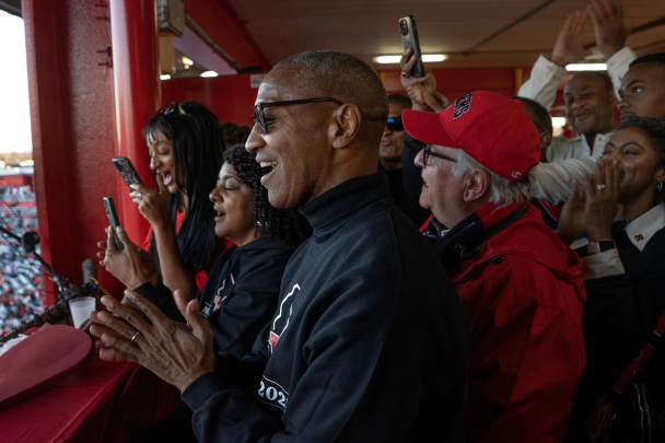 President Tate celebrates with others as Rutgers defeats Maryland a day after Tate's inaugural ceremony.