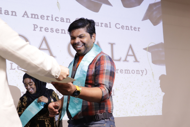 Student receiving the AACC stole on stage