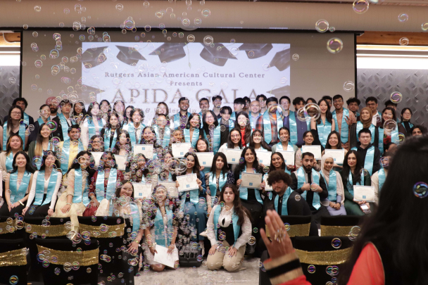 all of the AACC student leaders on stage after receiving their awards and stole with bubbles floating around them