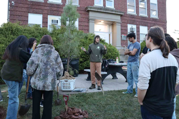 Outside Waller Hall in New Brunswick, N.J., Josh Kover speaks with Rutgers students during a tree planting and presentation he did in November.