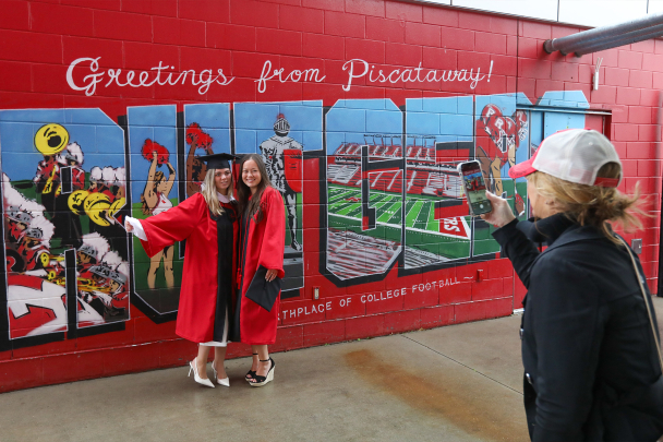 Grads having their picture taken at SCI stadium