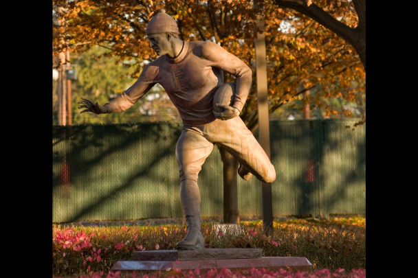 First Football Game Monument outside Rutgers SHI Stadium on Busch campus commemorating the first intercollegiate football game, amid fall foliage