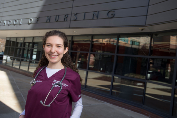 Alumna Anne Vrubliauskas stands outside the Rutgers School of Nursing building