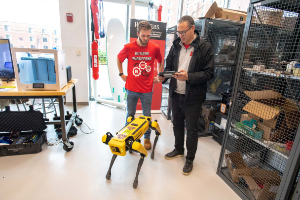 President Holloway with student and Spot the Robot dog