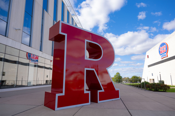 R Logo sculpture under a bright blue fall sky on Livingston campus