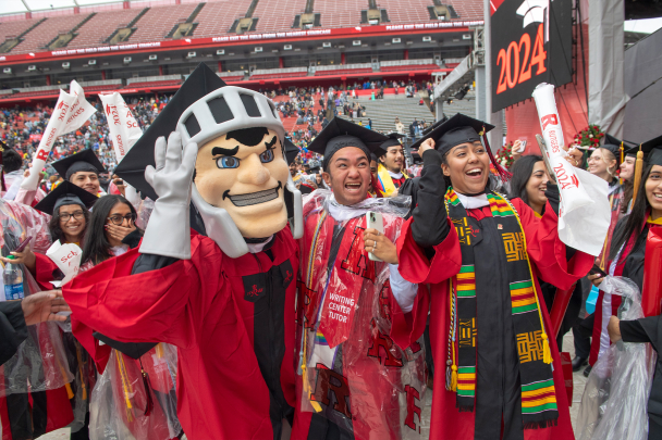 School of Arts and Sciences graduates celebrate with the Scarlet Knight at Rutgers University Commencement in SCI Stadium