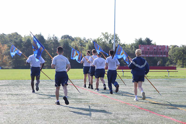 Cadets practice "double time" pacing with guidon flags during this introductory drill lab at University Park in September.