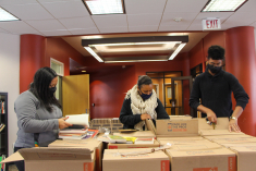 Jakora Holman, director of Rutgers University-New Brunswick’s Paul Robeson Cultural Center; Camara Epps, daughter of Cheryl Wall; and Philip Chambers, the PRCC assistant director, sort through dozens of boxes of books that Wall’s family donated to the center