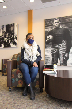 Cheryl Wall’s daughter, Camara Epps, with a few of nearly 2,000 books from Wall’s collection she is donating to Rutgers University-New Brunswick’s Paul Robeson Cultural Center.