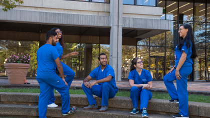 Rutgers Health Dental Students sitting in a group outside